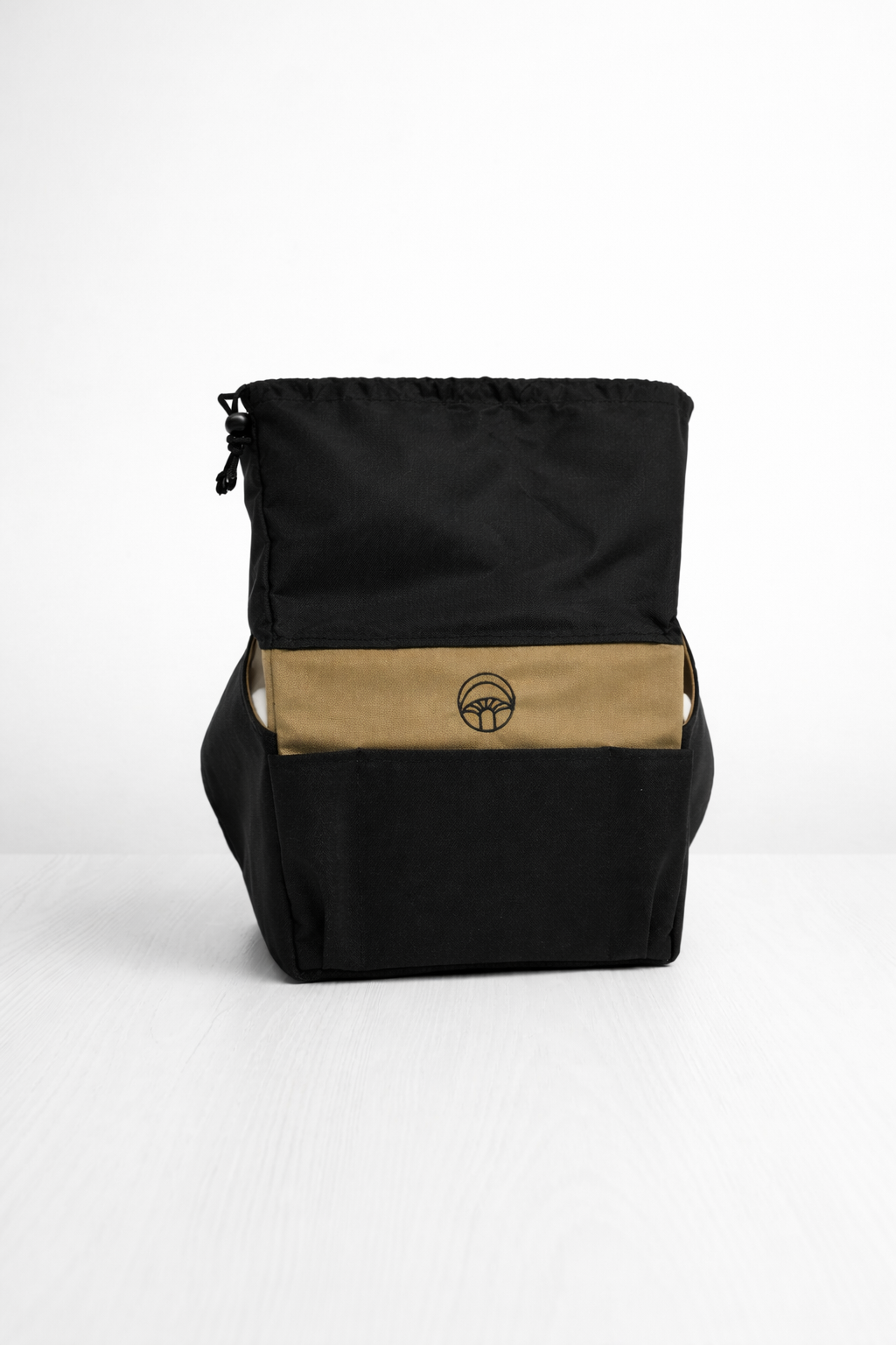 Black backpack with a beige stripe featuring a logo on a white background